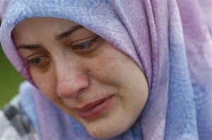 A Bosnian Muslim woman, Nisveta Salihovic cries near the coffin of her father during a funeral for 31 Bosnian Muslims killed at the beginning of the 1992-95 Bosnian war, in the Bosnian town of Bratunac, 100 km east of Sarajevo, Bosnia, on Wednesday, May 12, 2010. All the victims, which included two young girl, were exhumed from mass graves and identified by DNA.(AP Photo/Amel Emric)